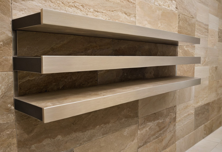 Close view of natural stone, oak veneer and brushed metal samples arranged on a shelf